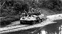light armored car M8 moving along a river bank on Mindanao