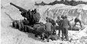 GUN CREW SETTING UP A 155-MM. GUN M1A1 on one of the Keise Islands