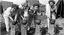 ARMY NURSES ON OKINAWA washing in helmets
