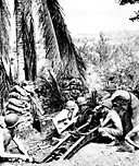 MARINES ON GUADALCANAL in October 1942 firing a 75-mm. pack howitzer