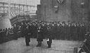 CAPTAIN R. T. McELLIGOTT, USCG (RIGHT) HEARS HIS ORDERS ON TAKING COMMAND OF USS CAVALIER (APA-37)