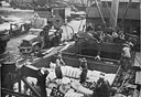 BROUGHT BY ITS COAST GUARD CREW THROUGH THE MAZE OF REEFS AND ATOLLS TO AN ADVANCE SOUTH PACIFIC BASE THIS ARMY FS (FREIGHT SUPPLY) SHIP GIVES UP ITS CARGO OF SUPPLIES FOR UNCLE SAM's PACIFIC INVADERS