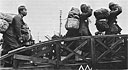 Repatriated Japanese soldiers salute American flag upon boarding LSTs returning them home to Japan.