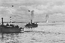 Two PT's stand by during a bombing attack on shipping in Leyte Gulf
