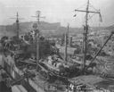 Cimarron under refit at Mare Island Navy Yard in November 1942. Major changes included modification to the fueling gear (cargo deck, raised winch platforms, etc.); replacement of the original .50-caliber machine guns with 20mms; addition of a Mark 4 fire-control radar (mounted atop the gun director); and addition of an SC search radar atop the mainmast. (National Archives)