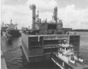 All five ships of the AO-177 class were
jumboized by adding a new midsection (shown 
here being pushed into place), which lengthened the ships by 117 feet and 
increased the cargo capacity to 183,000 barrels--large enough to 
provide two complete refuelings of a conventional aircraft carrier and 
her accompanying escorts. (U.S. Naval Institute)