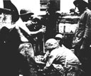 Figure 76.--Transfusion of wounded immediately upon arrival aboard a landing craft.